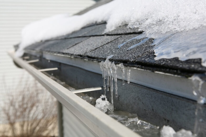 Professional gutter guard installation preventing ice dam formation.