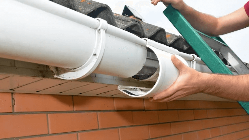 A hand showing the gutter size that is being installed